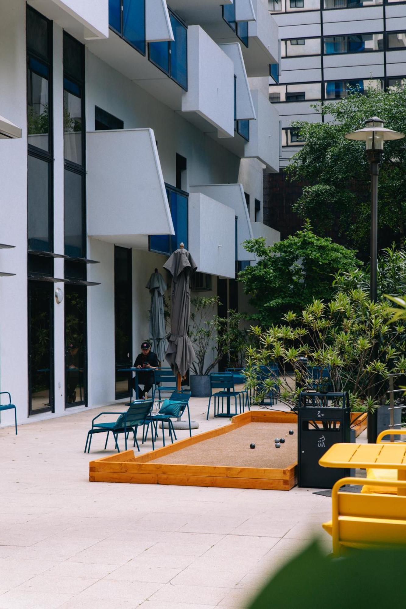 Fraser Suites Paris La Defense Courbevoie Exterior photo A bocce ball court in the courtyard of the University of New South Wales, Australia